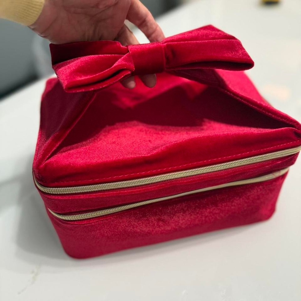 Red velvet Estee‎ Lauder makeup bag with a bow